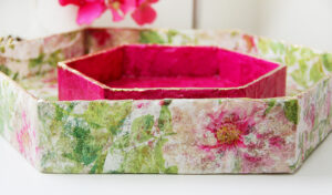 Small, pink basket in bigger, floral basket.