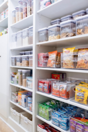 Snacks organized in kitchen pantry.