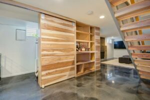 Natural wood bookshelf against wall.