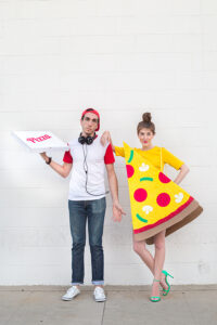 Couple dressed up in pizza costumes.