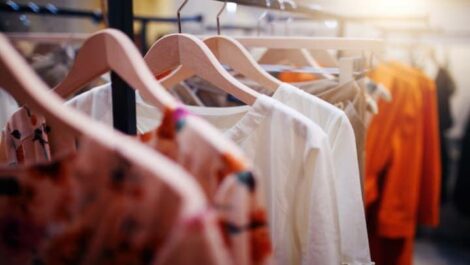 Garments hanging on a clothing rack in a store.