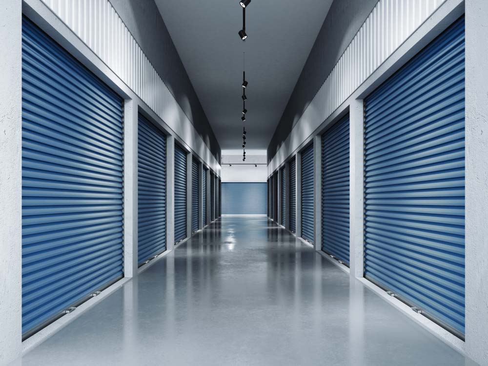 Inside storage facility looking down hallway with indoor units.