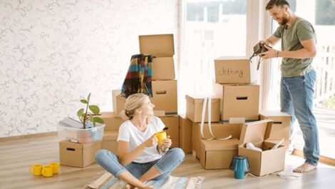 A happy couple packing moving boxes.