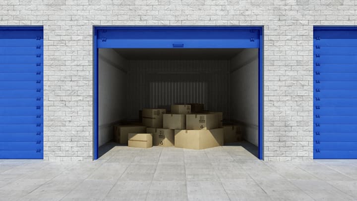 Pile of boxes in the middle of a storage unit.