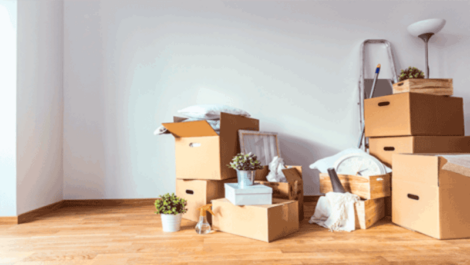 Cardboard boxes stacked in a living room.