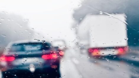 Driving in rain on a busy highway.