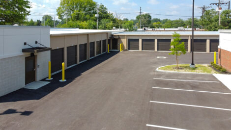 Outside Storage Units with Garage like Doors and Packing Lot.