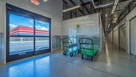 Indoor Storage with Garage like Doors and Green Carts.