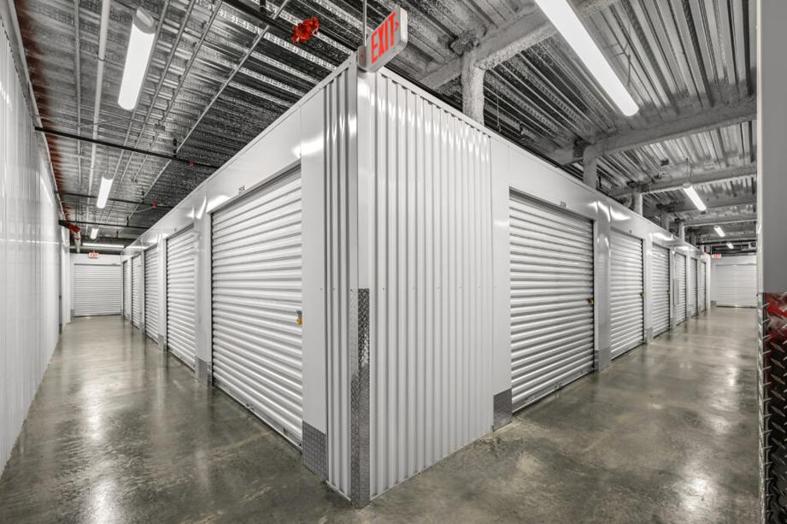 Inside of storage facility looking down hallways of indoor units.