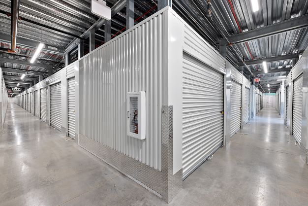 Inside of storage facility looking down hallways of indoor units.