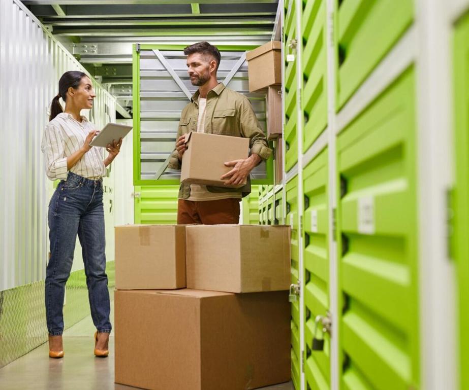 Supervisor organizing boxes on racks, carrying packages before