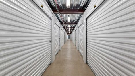 Inside of storage facility looking down hallway of indoor units.