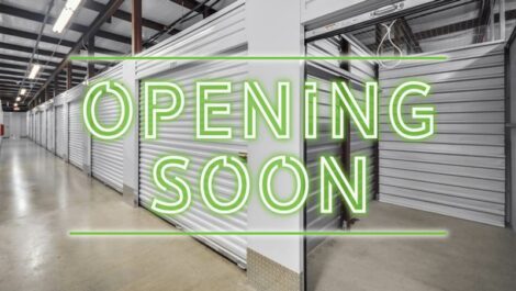 Opening Soon Sign with Indoor Storage that has Garage like Doors in the Background.
