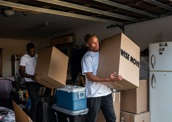 Two men moving storage boxes.
