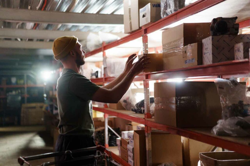 a man putting a box on the shelf as a way to choose the right self-storage unit. 