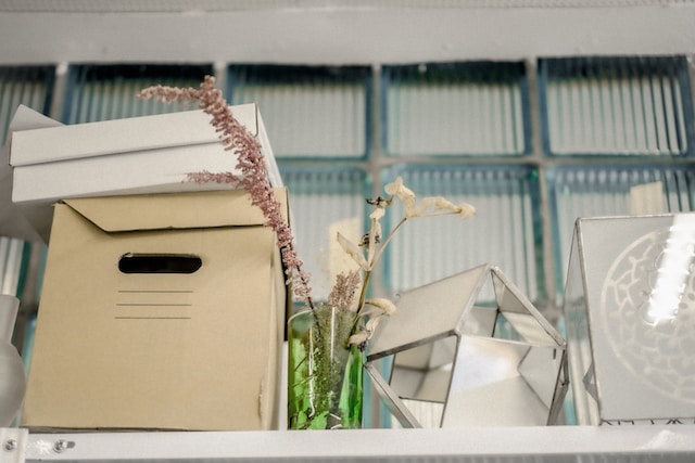 Cluttered items surrounding box.