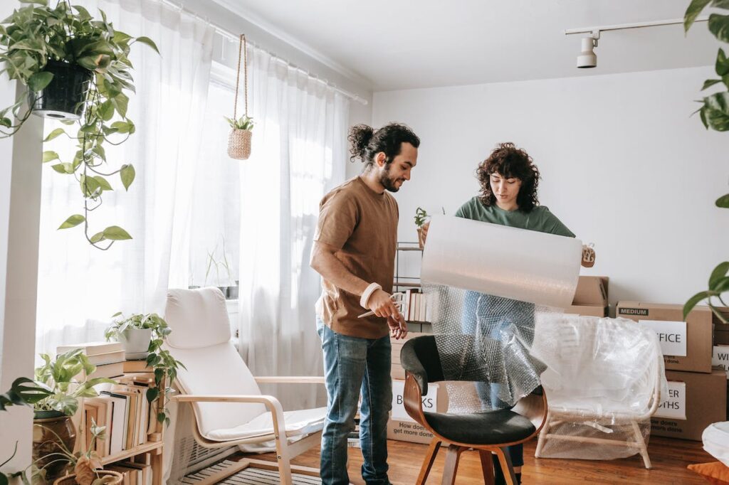 A couple packing furniture for storag