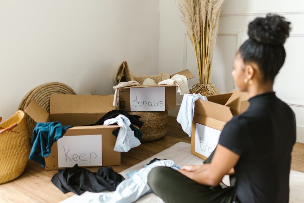 A woman decluttering her things is a key step to take when you prepare your items for self-storage