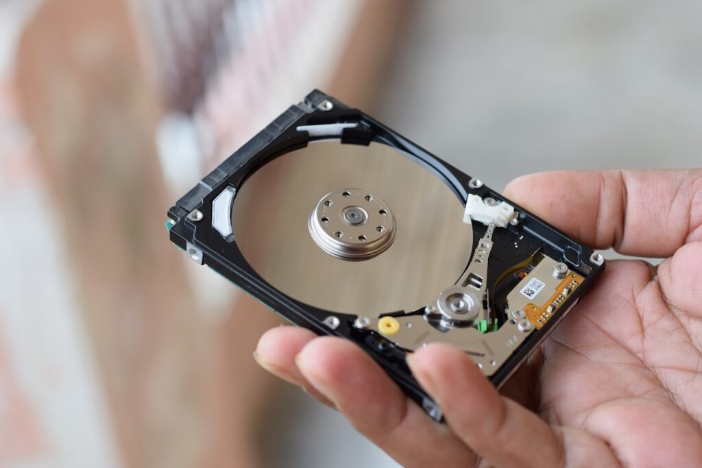  A person handling a hard drive while preparing your electronics for long-term storage

